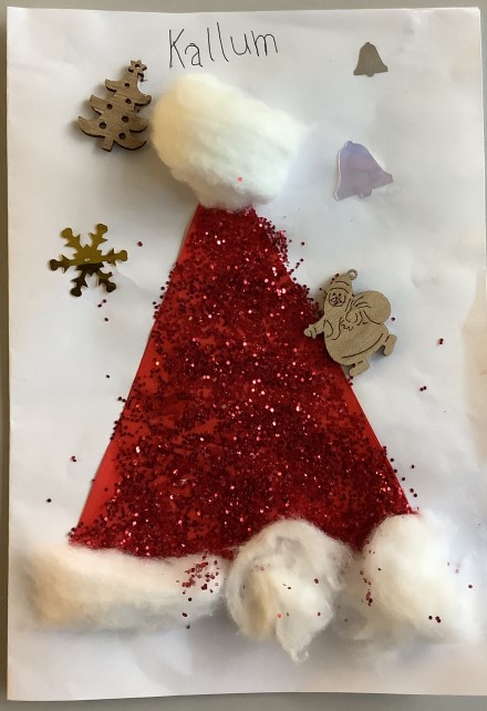 A Christmas hat made up of red glitter and cotton balls. 